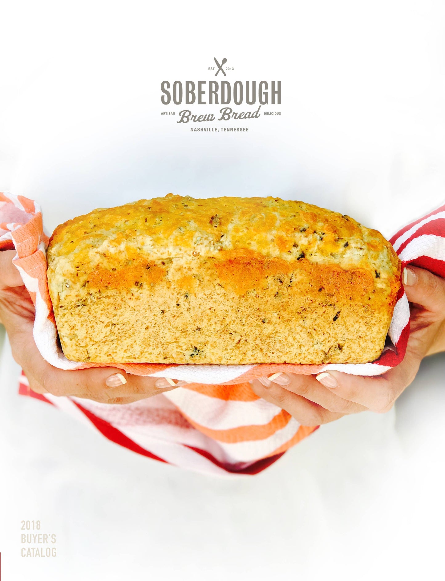 Loaf of bread held by hands with a 'Soberdough' branding on a white background