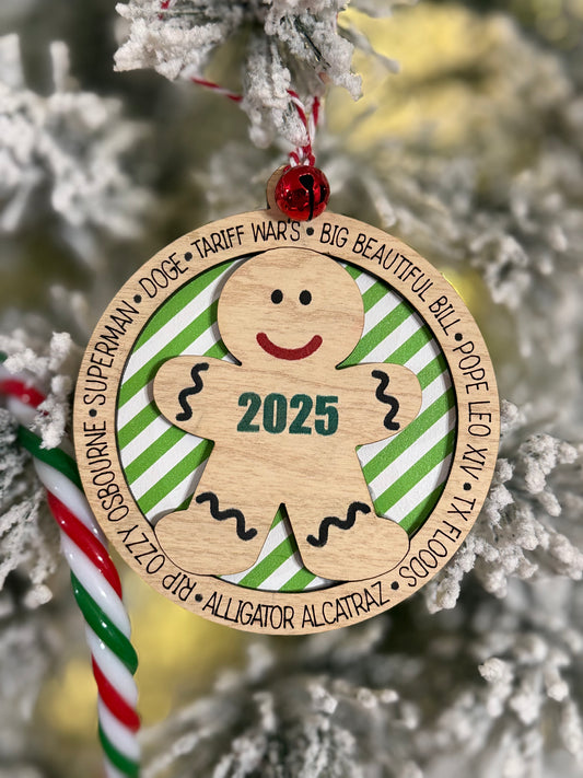 Wooden ornament with a gingerbread man design and '2025' on a Christmas tree.