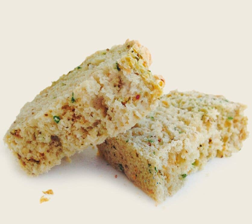 Two pieces of biscotti on a light beige background