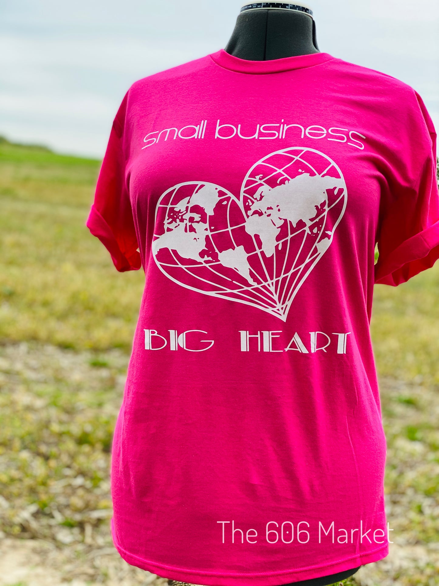 hot pink t-shirt with small business big heart on front  and a heart shape globe printed on front of t-shirt