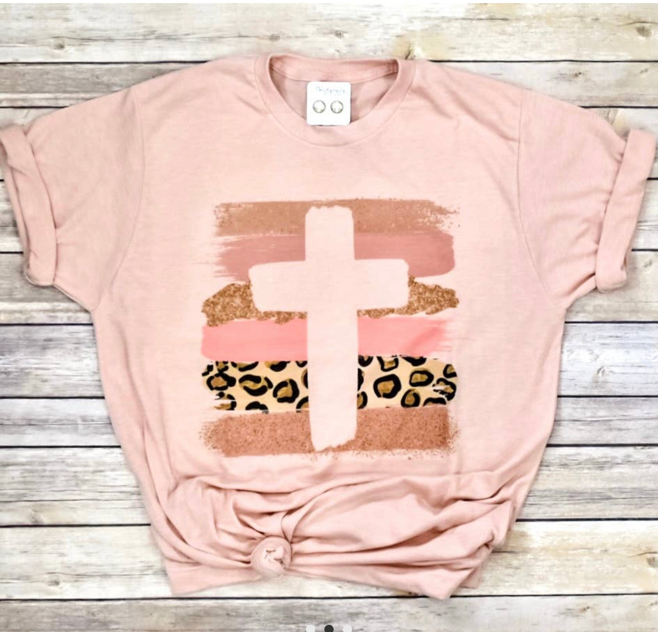 Peach t-shirt with a cross imprinted on 6 different colored horizontal columns